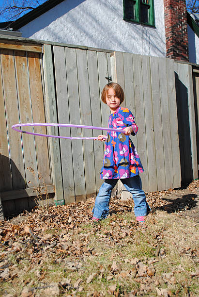 istock Young girl spinning a hula hoop 509108230