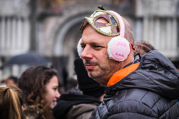 Venice, Itlay - February 9, 2016: Crowds and carnival revellers dress up and gather in Venice to enjoy Mardi Gras and the final day of the 2016 Venice Carnival.