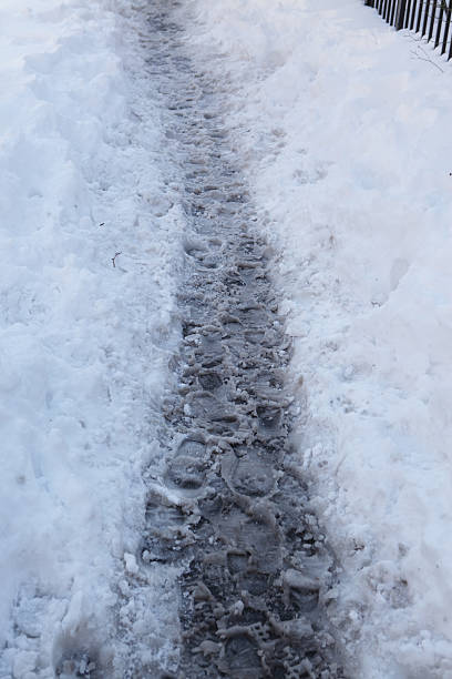 istock Footprints in snow on a Brooklyn sidewalk after winter storm 509112048