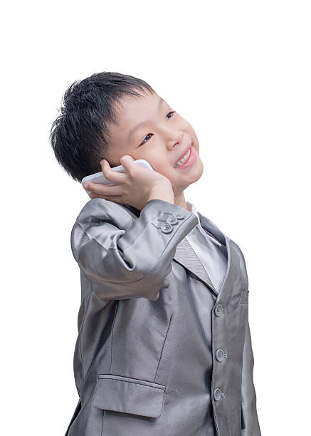 istock Asian boy in suit talking on mobile phone 509112289