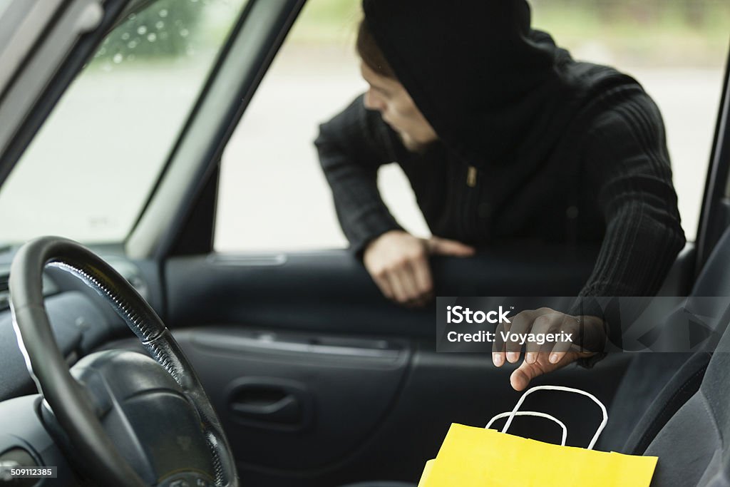 thief stealing shopping bag from the car Transportation, crime and ownership concept - thief stealing shopping bag from the car Adult Stock Photo