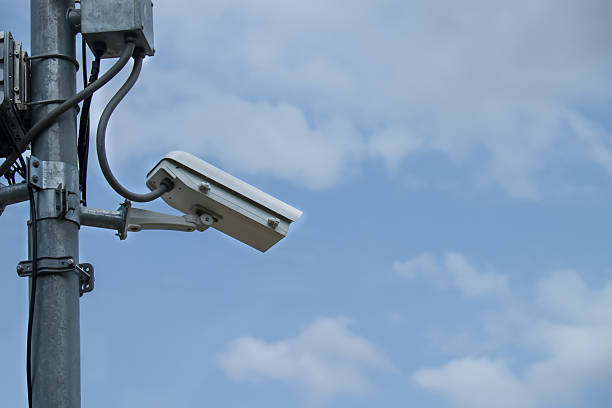 istock Close up of white security camera and white sky 509113025