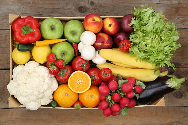 istock Healthy eating fruits and vegetables in box from above 509113155