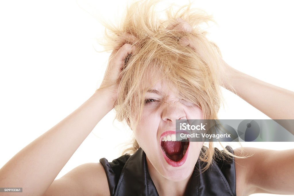 Angry furious woman screaming and pulling messy hair Angry businesswoman crazy boss furious woman screaming and pulling messy hair isolated on white. Stress and negative emotions. Adult Stock Photo
