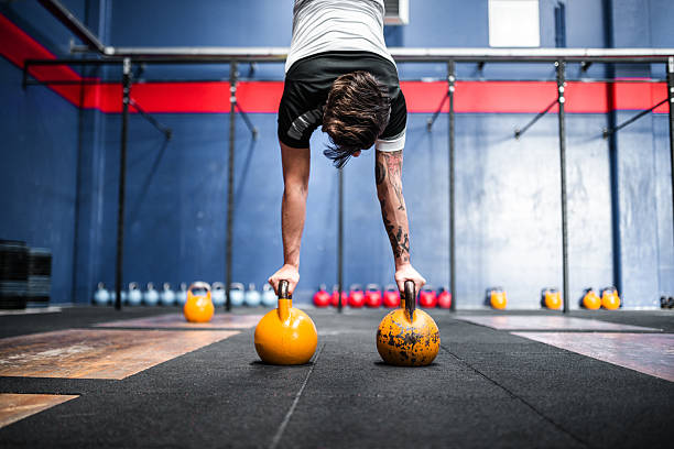 istock man keeping the balance on the kettlebells 509113374