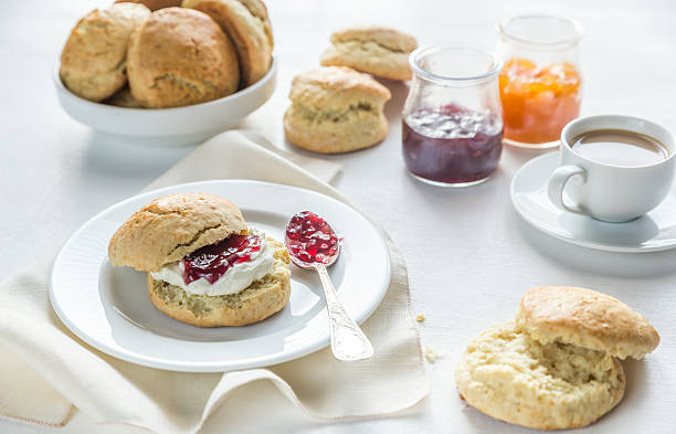 istock Scones with cream and fruit jam and cup of coffee 509113544