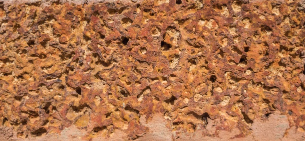 Closeup details texture of Laterite Stone used as brick wall in Buddhist temple