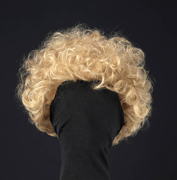 istock female blonde wig on a black background 509115197