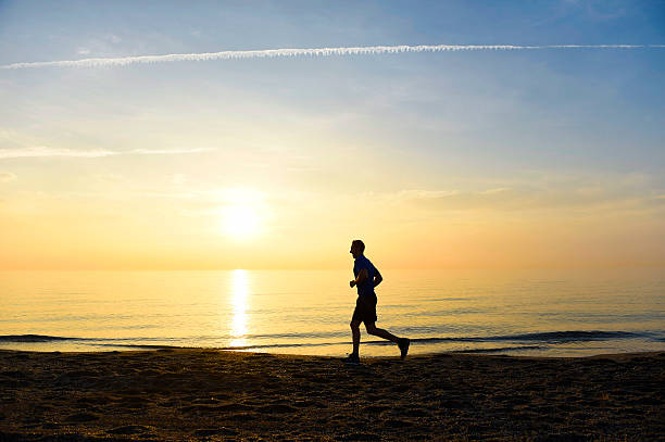 istock silhouette young sport man running on beach sunset orange sky 509115738