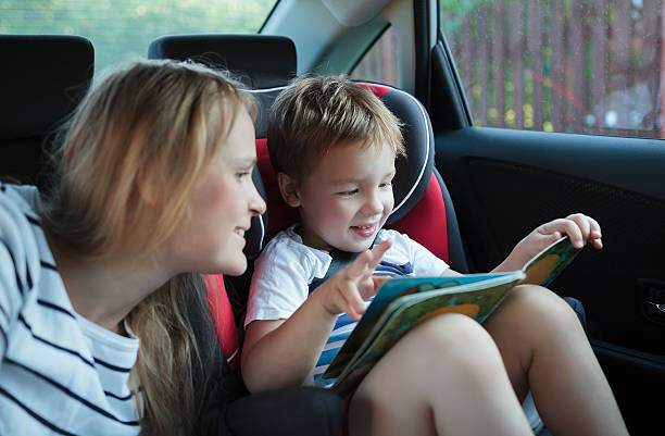 istock Mother and son with a book in the car 509115849