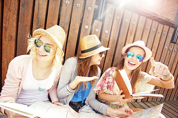 istock Group of joyful tourists using map in the city 509116142