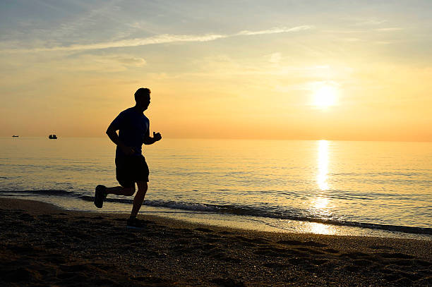 istock silhouette young sport man running on beach sunset orange sky 509116316
