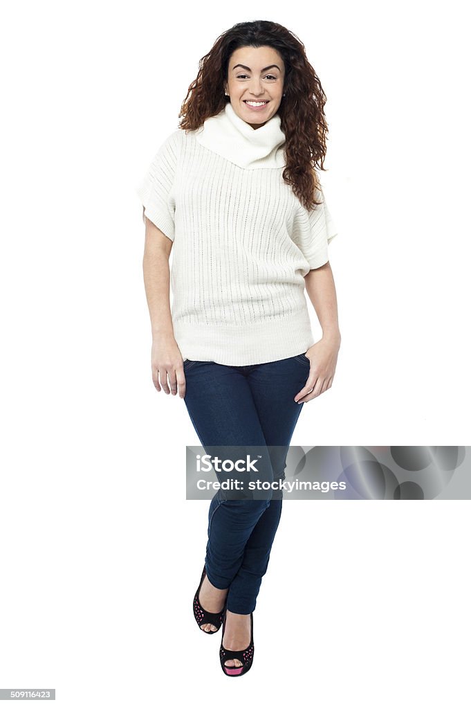 Fashionable woman in trendy casual wear Full length portrait of a cheerful woman wearing high neck top isolated against white. Adult Stock Photo