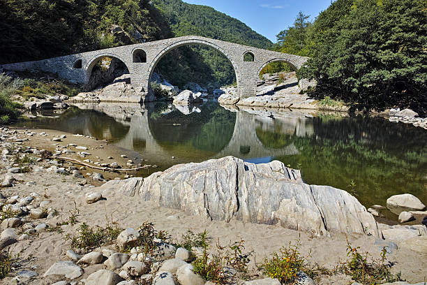 istock Reflection of Devil's Bridge in Arda river and Rhodopes mountain 509116580