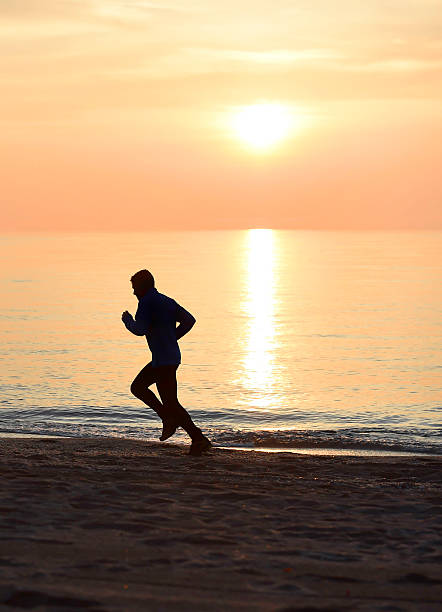 istock silhouette young sport man running on beach sunset orange sky 509116874