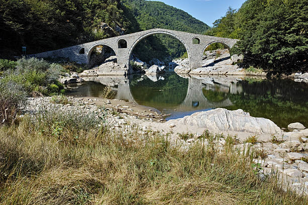 istock Reflection of Devil's Bridge in Arda river and Rhodopes mountain 509117022