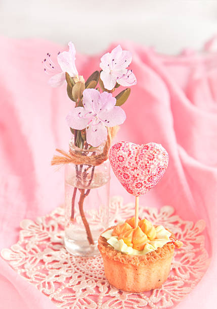 Sweet tartlet decorated gift-heart in pink stock photo
