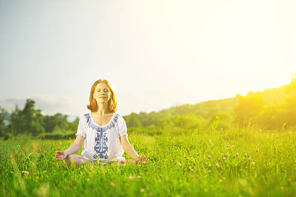 istock young woman doing yoga on green grass 509118295