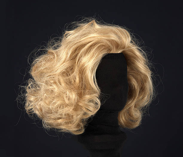 blonde wig isolated on black background blonde feminine wig on black background and textile mannequin. wig stock pictures, royalty-free photos & images