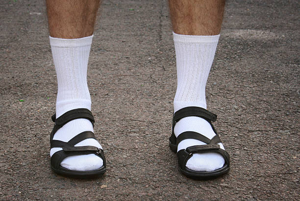 Men's feet in sandals The lower part of men's feet in white socks and sandals sandal stock pictures, royalty-free photos & images