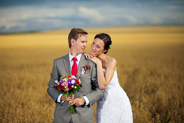 istock Cute romantic wedding couple on  field at sunset 509119326