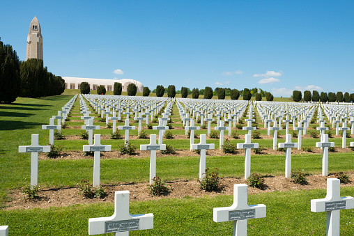 Douaumont, France - May 17, 2014: The graves of French soldiers lie outside the Douaumont Ossuary, located on the Verdun battlefield in France. With 16,142 graves, it is the largest single French military cemetery of the First World War. It was inaugurated in 1923 by Verdun veteran Andre Maginot, who would later design the Maginot Line.