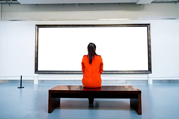 Young woman looking at artwork