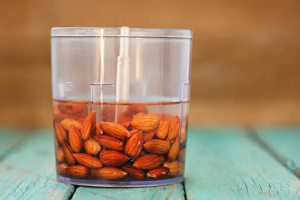 Soaked almonds ready for making almond milk in blender copyspace
