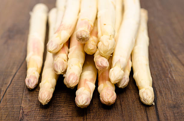 istock White asparagus on brown wood table 509137243