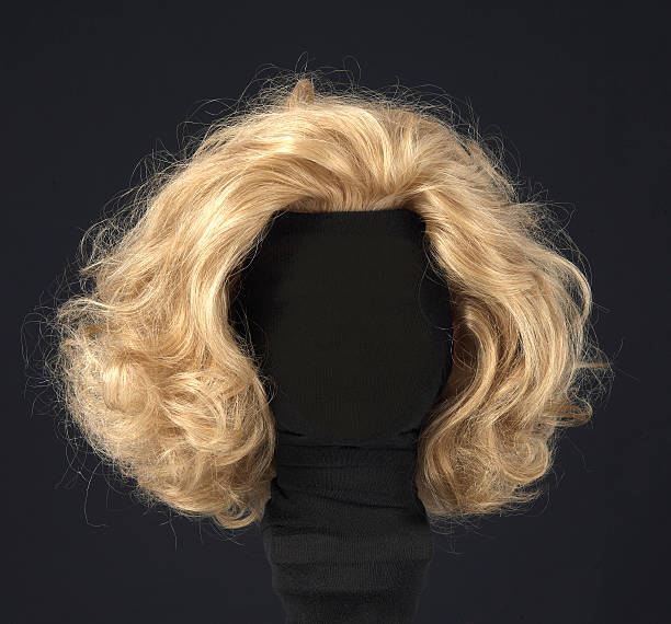 blonde wig isolated on black background blonde feminine wig on black background and textile mannequin. blonde hair stock pictures, royalty-free photos & images