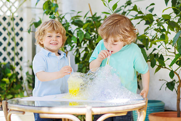 istock Two happy children making experiment with colorful bubbles 509139697