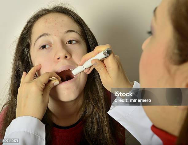 Pediatric Doctor Examining Girls Throat Stock Photo - Download Image Now - Anxiety, Care, Child