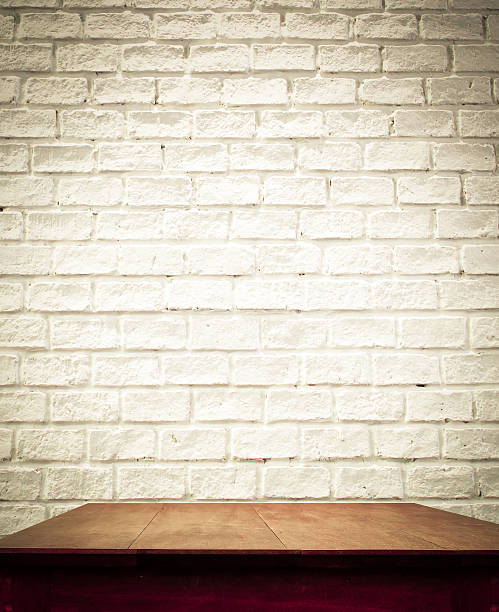 istock white brick wall and wooden table 509140283