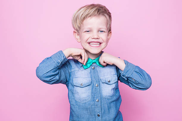 istock Young beautiful boy with blue shirt and butterfly tie 509167406