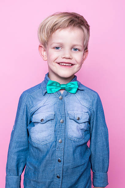 istock Young handsome kid smiling with blue shirt and butterfly tie 509167494