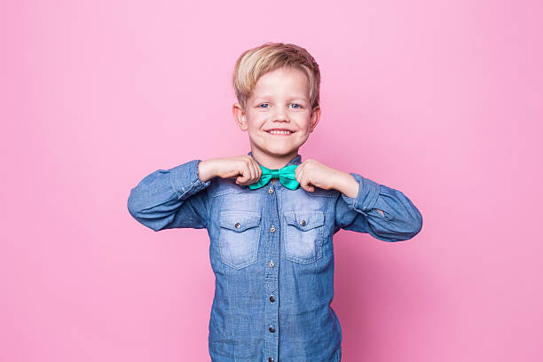 istock Young handsome kid smiling with blue shirt and butterfly tie 509167588