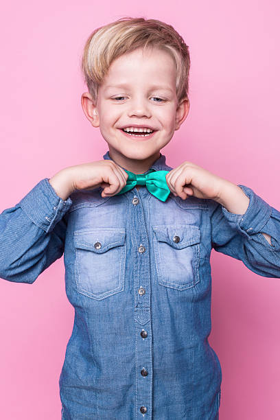 istock Young handsome kid smiling with blue shirt and butterfly tie 509167642