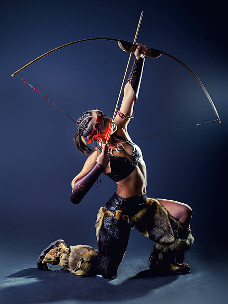 A young girl in image Northern warrior woman shoots an arrow with a knee