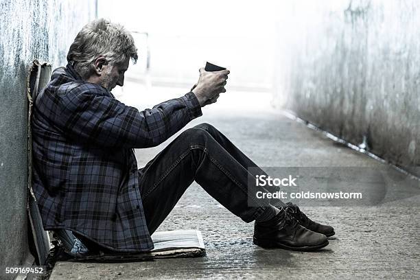 Homeless Senior Adult Man Sitting And Begging In Subway Tunnel Stock Photo - Download Image Now