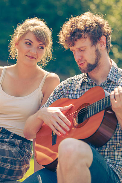 istock Young couple camping playing guitar outdoor 509170768