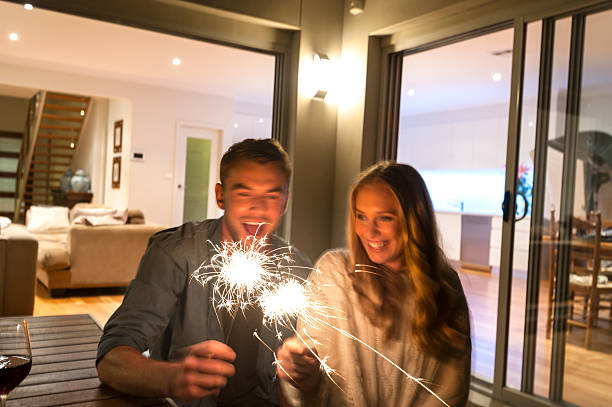 istock Couple with sparklers outside their home at night. 509172184