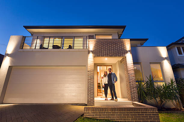 istock Couple standing in front of their new home 509172408
