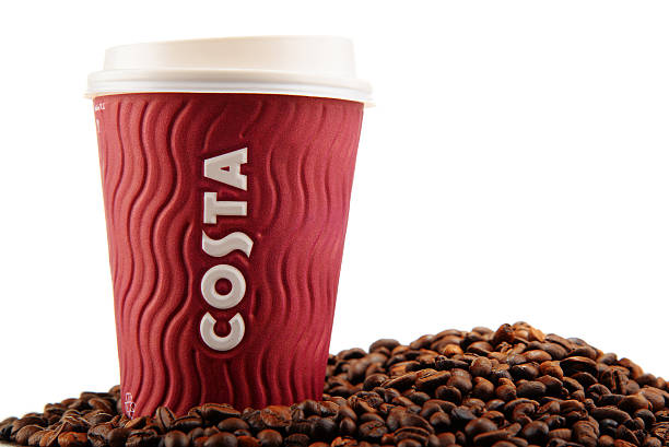 Composition with cup of Costa Coffee coffee and beans Poznan, Poland - January 29, 2016: Costa Coffee is a British multinational coffeehouse company headquartered in Dunstable, Bedfordshire; second largest coffeehouse chain in the world. costa coffee stock pictures, royalty-free photos & images