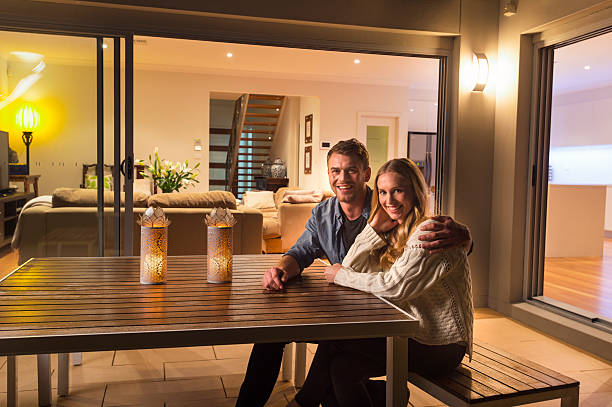 istock Couple sitting outside their home at night. 509172888