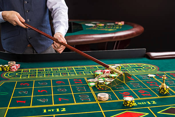 istock croupier collects chips using stick in casino. 509174670
