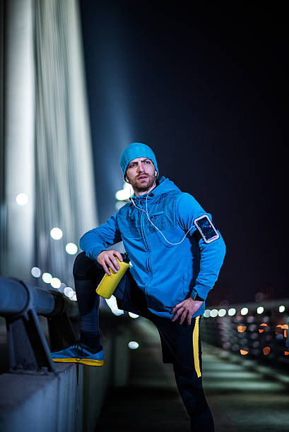 istock Man jogging through the city at night 509174898