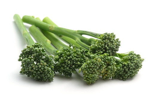 Broccolini also known as tenderstem broccoli, isolated on a white background.