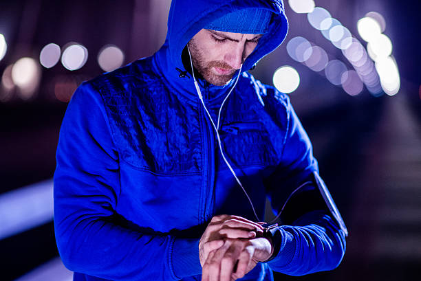 istock Young man jogging through the city at night 509175566