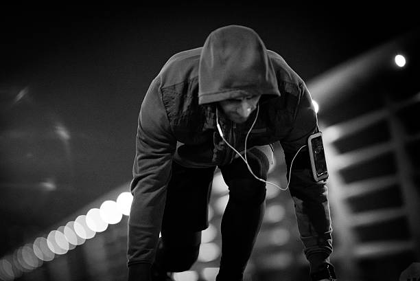 Young sports man in start position preparing to run