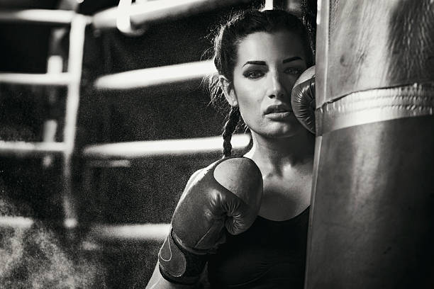 istock Female boxer standing by a punching bag 509178944